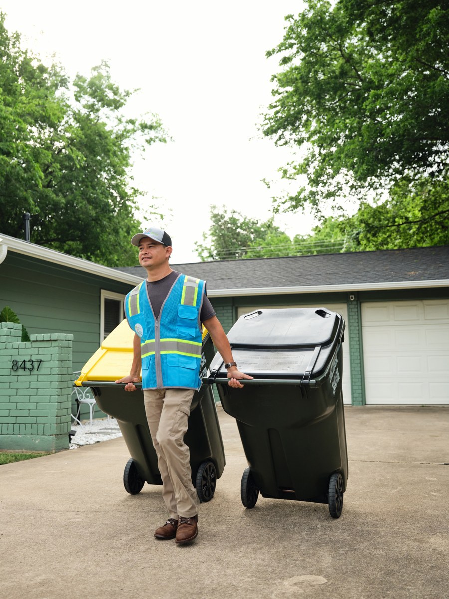 Bubble Binz crew member rolling clean bins back to the curb