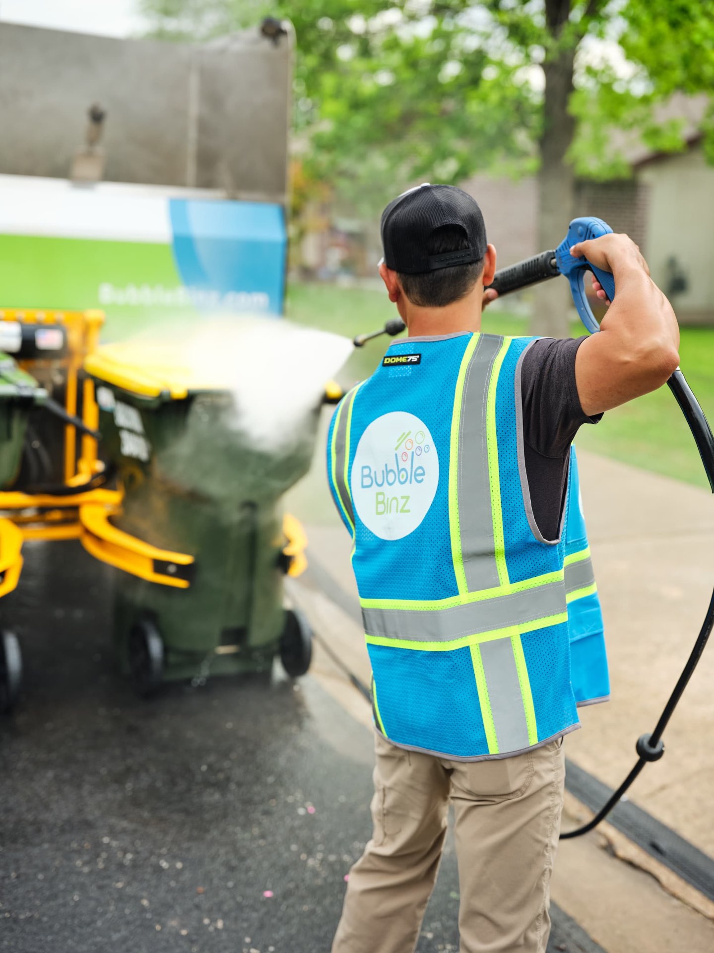 Team member spraying bins
