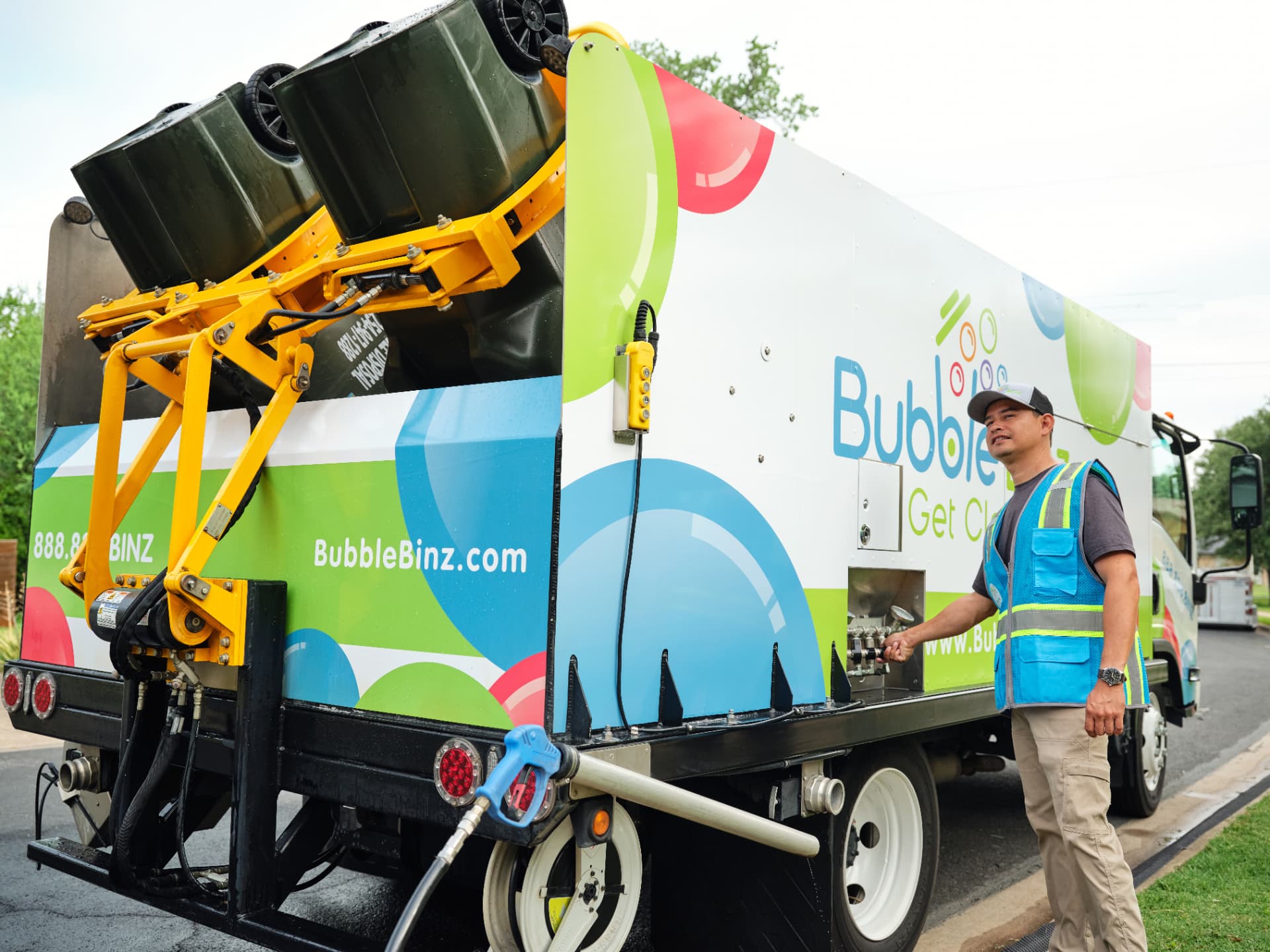Bubble Binz crew member beside a bin-cleaning truck
